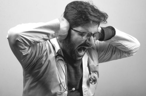 A doctor stressed frustrated at work freaking out  - Black and White